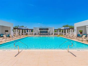 A large swimming pool with a clear blue sky above.